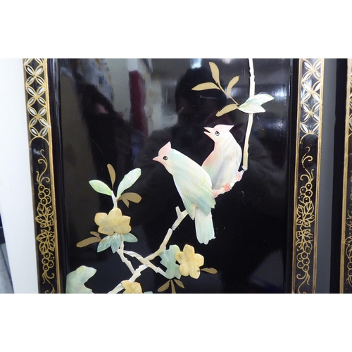 198 - A pair of modern, black lacquered chinoiserie panels, decorated with resin floral and birds  ea... 