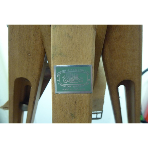 203 - A Windsor & Newton artists' stained beech folding easel, on a tripod stand  76