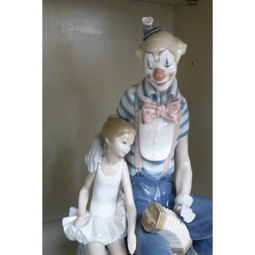 216 - A Lladro porcelain group, a clown seated beside a ballerina  13.5