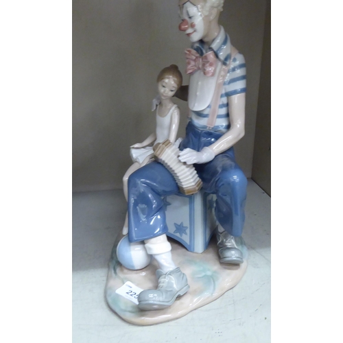 216 - A Lladro porcelain group, a clown seated beside a ballerina  13.5