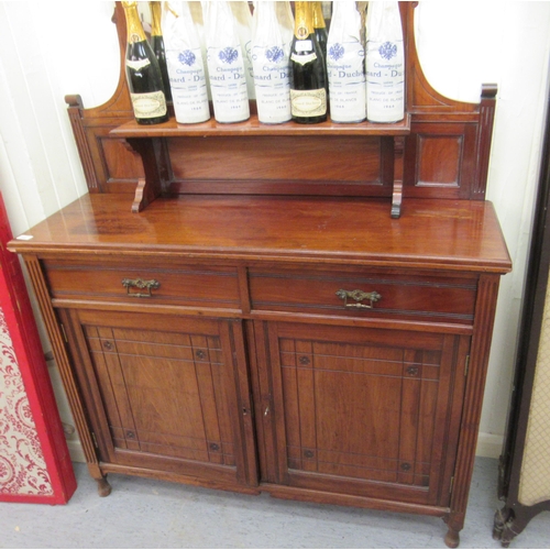 218 - An Edwardian mahogany sideboard, the mirror backed superstructure over two inline drawers and a pair... 