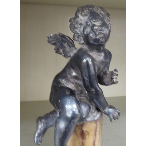 235 - A 20thC silver plated cherubic ornament, on a marble pedestal and square plinth  9.5