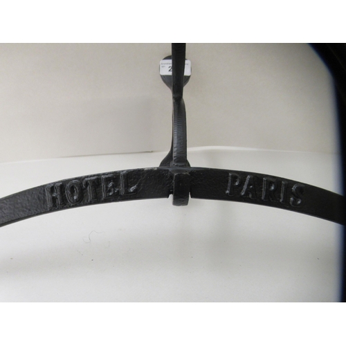 245 - A modern replica of a Victorian Parisian hotel, black painted wall mounted metal valet bracket