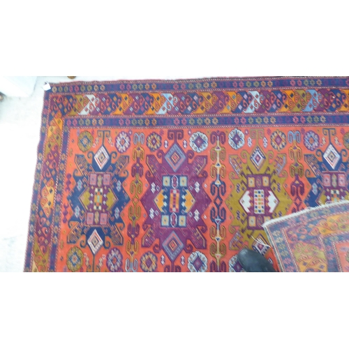 24 - A Persian rug, decorated with repeating design, in bright colours  60