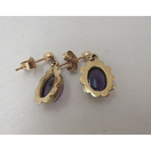 251 - A pair of 9ct gold framed and amethyst set earrings