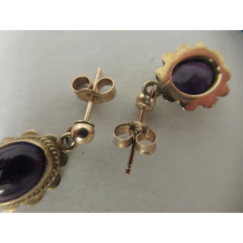 251 - A pair of 9ct gold framed and amethyst set earrings