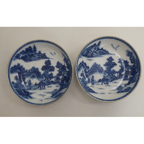 257 - Two late 18thC Chinese porcelain cups and saucers, traditionally decorated with landscapes and gilt ... 