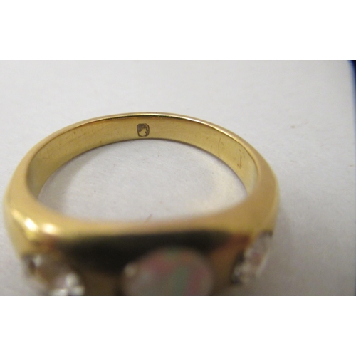 260 - A yellow metal ring, set with a central (broken) opal, flanked by two teardrop diamonds  boxed