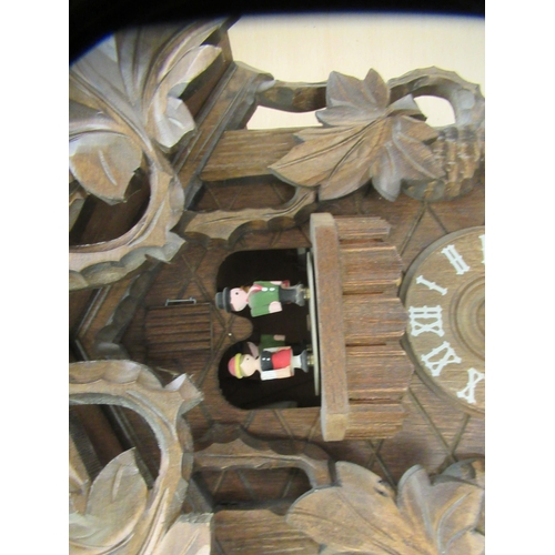 267 - Two clocks: to include a modern Black Forest inspired carved and stained beech framed cuckoo clock  ... 