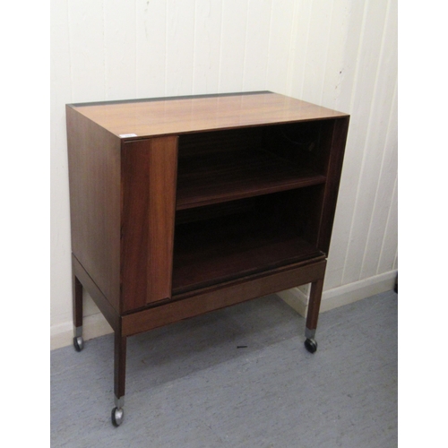 285 - A 1970s rosewood finished record cabinet with a horizontal sliding, tambour front, raised on square ... 