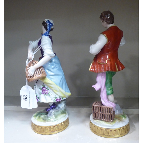 29 - A pair of early 20thC Continental porcelain figures, a man and a woman holding bird cages  8