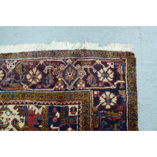 37 - A Persian carpet, decorated with repeating stylised designs, on a multi-coloured ground  94