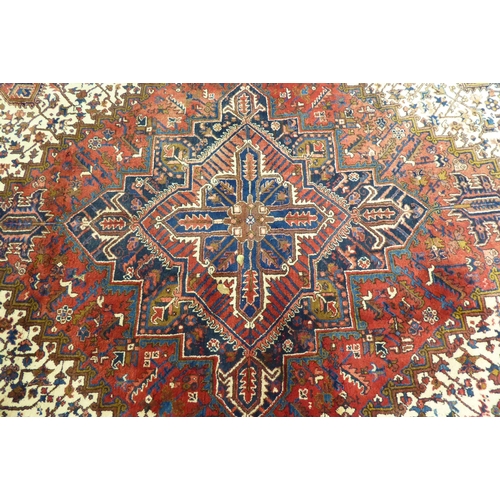 37 - A Persian carpet, decorated with repeating stylised designs, on a multi-coloured ground  94