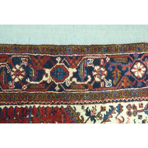 37 - A Persian carpet, decorated with repeating stylised designs, on a multi-coloured ground  94