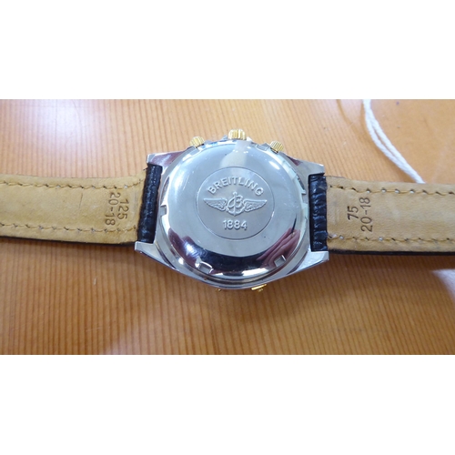 56 - A stainless steel cased wristwatch, on a black hide strap 