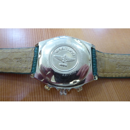 61 - A gold plated wristwatch, on a green hide strap