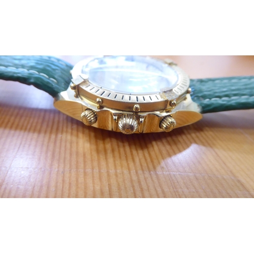 61 - A gold plated wristwatch, on a green hide strap