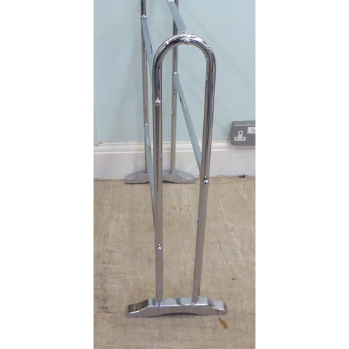 62 - A modern chromium plated, tubular steel towel rail, on splayed feet  29