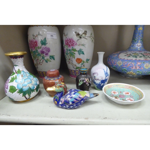 71 - Oriental collectables: to include a pair of mid 20thC Chinese porcelain vases, decorated with flower... 