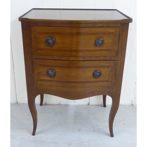 81 - A 20thC mahogany two drawer bedside chest, raised on cabriole legs  29