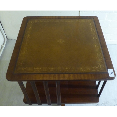 86 - A 20thC reproduction of a Georgian mahogany framed revolving bookcase, on splayed feet  22