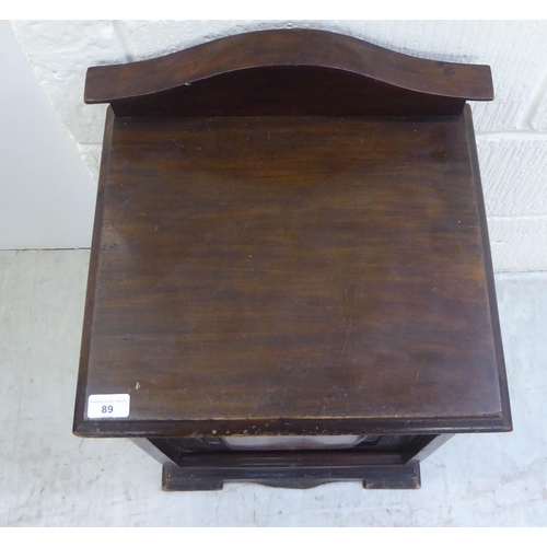 89 - A 20thC early 20thC mahogany purdonium with a fall flap, raised on  bracket feet  24