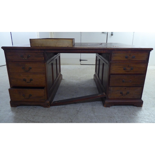 95 - A late 19th/early 20thC mahogany twin pedestal partners desk with an arrangement of eighteen drawers... 