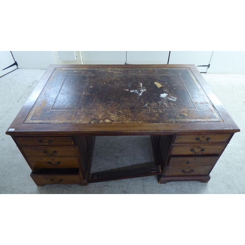 95 - A late 19th/early 20thC mahogany twin pedestal partners desk with an arrangement of eighteen drawers... 