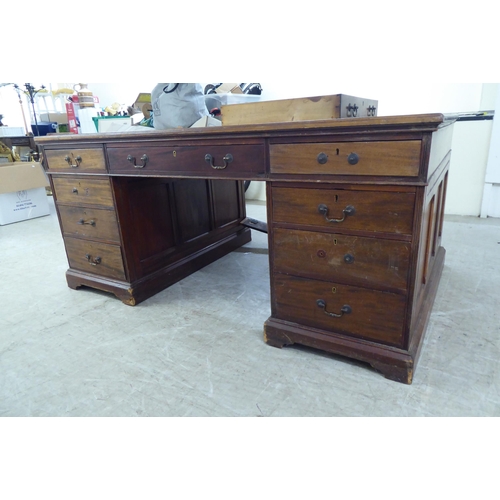 95 - A late 19th/early 20thC mahogany twin pedestal partners desk with an arrangement of eighteen drawers... 