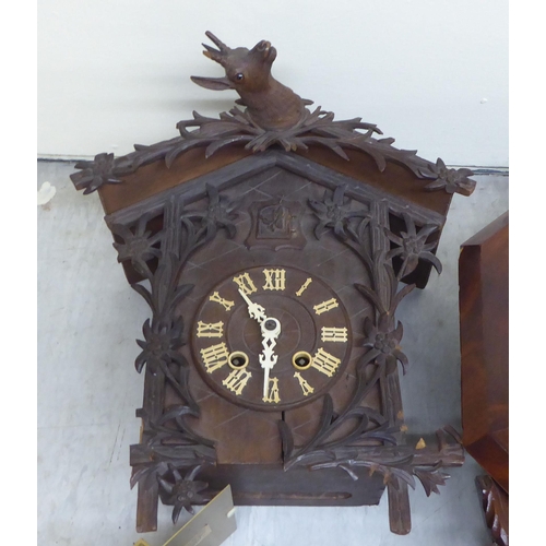 98 - A mixed lot: to include a 20thC Black Forest inspired, carved, stained beech cased cuckoo clock  14