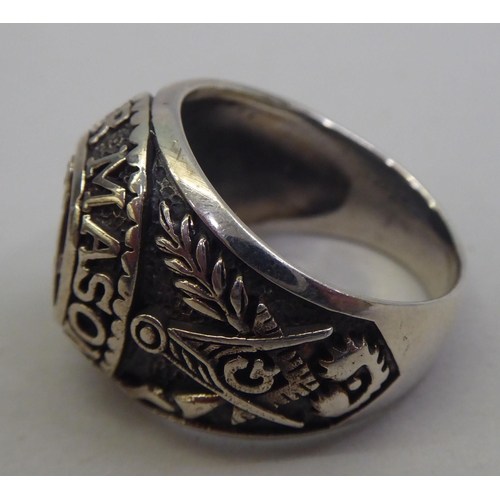 30 - A gentleman's silver ring, decorated with Masonic devices