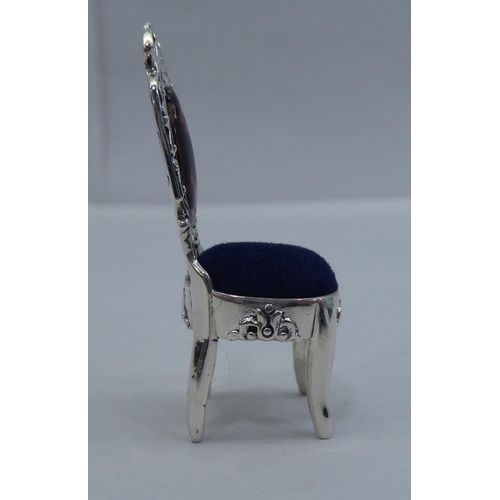 42 - A miniature silver novelty pin cushion, fashioned as an antique chair&nbsp; stamped Sterling