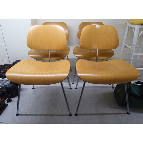 47 - A set of four Charles Eames Original Plywood Group for Vitra chairs, each with a moulded back panel ... 