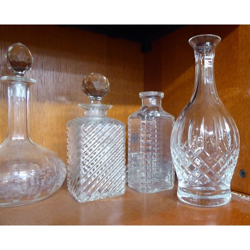 12 - Glassware: to include a clear and cranberry coloured cordial jug and six decanters