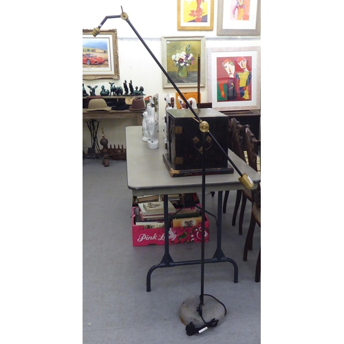 228 - A modern Loaf standard lamp with a counterbalanced bi-coloured steel stem, on a height adjustable an... 