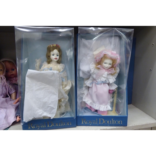 32 - Early 20thC and later china, plastic and other dolls: to include four examples by Royal Doulton from... 