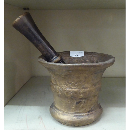 83 - A cast bronze pestle and mortar, the mortar with collared sides  6