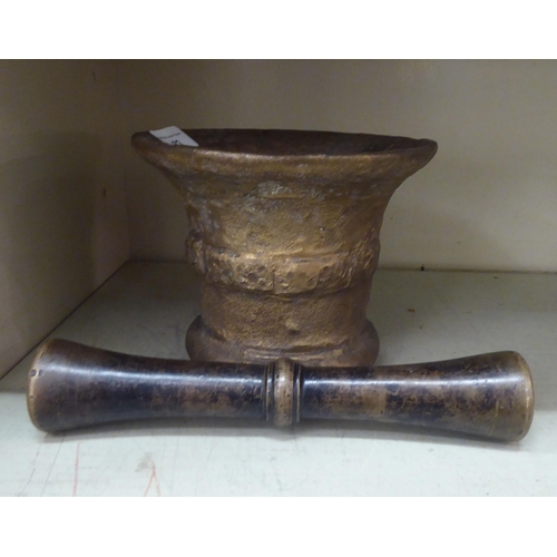 83 - A cast bronze pestle and mortar, the mortar with collared sides  6