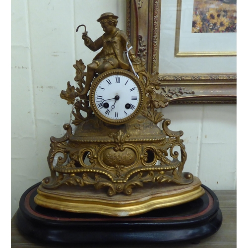 10 - An early 20thC (probably French) gilt metal mantel clock, fashioned as a figure wearing period dress... 