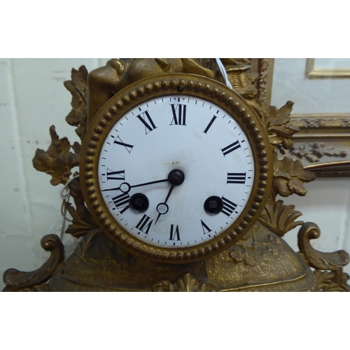 10 - An early 20thC (probably French) gilt metal mantel clock, fashioned as a figure wearing period dress... 