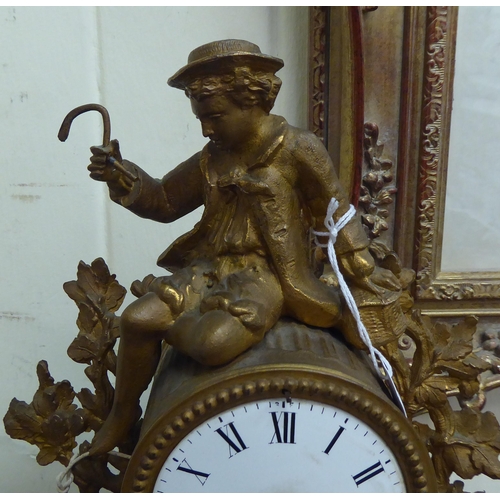 10 - An early 20thC (probably French) gilt metal mantel clock, fashioned as a figure wearing period dress... 