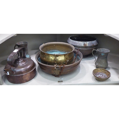 100 - Domestic metalware: to include a copper range kettle; North African brass drinking vessels and a cas... 