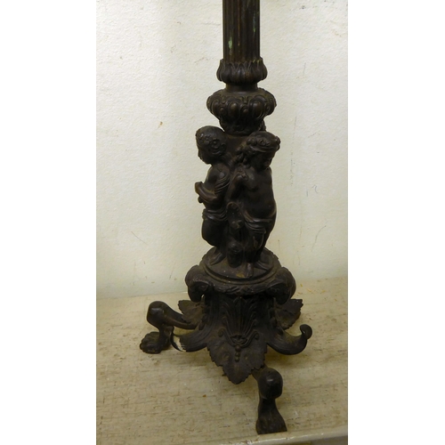 104 - A 19thC cast bronze table lamp, featuring five branches, over a central column, supported by three c... 