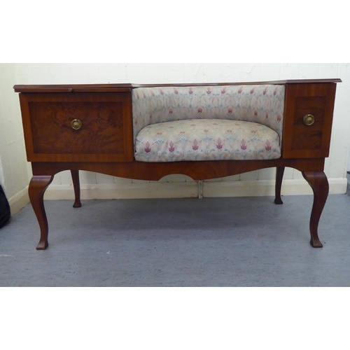 11 - A 1970/1980s mahogany finished telephone seat with a concave Art Nouveau inspired, fabric upholstere... 