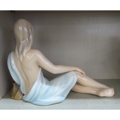 112 - A modern Italian pottery figure, a reclining woman  13