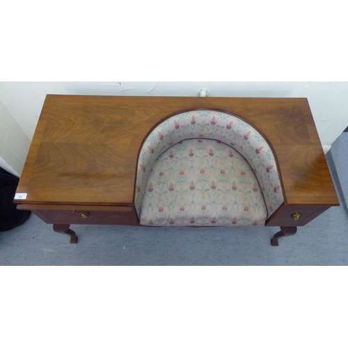 11 - A 1970/1980s mahogany finished telephone seat with a concave Art Nouveau inspired, fabric upholstere... 