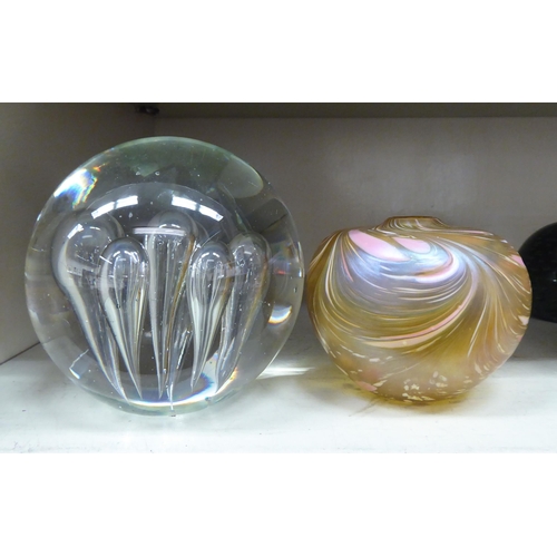 121 - Modern glass paperweights and ornaments: to include a bubbled, bulbous door stop; and a swirling, mu... 