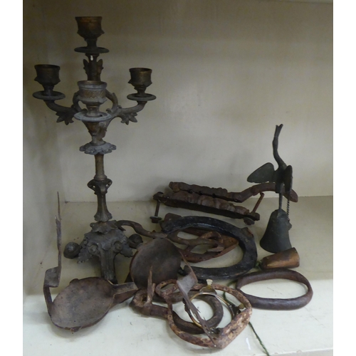 122 - A late 19thC cast iron cork press; and an iron triple branch candlestick  14