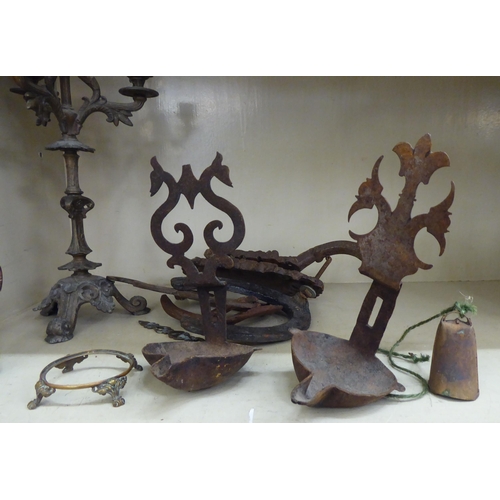 122 - A late 19thC cast iron cork press; and an iron triple branch candlestick  14