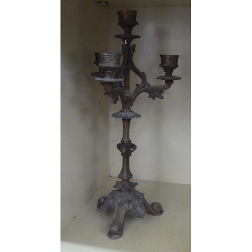 122 - A late 19thC cast iron cork press; and an iron triple branch candlestick  14